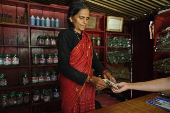 Harikala handling money during a transaction in her shop
