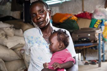 A mother holding a toddler in south sudan