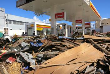 Scraps of sticks, plywood and tree branches blockade a damaged gas station. Scenes like this covered Tacloban, a formerly lively city of 220,000 people.