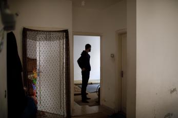 Bashar in a doorway inside his home