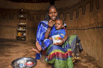 A young woman in ethiopia feeds her baby