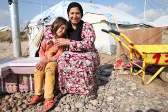 A woman embraces a girl in kawergosk refugee camp, erbil, iraq