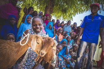 Nigerian girl with two goats in her community group