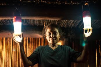 A woman holds two solar lights
