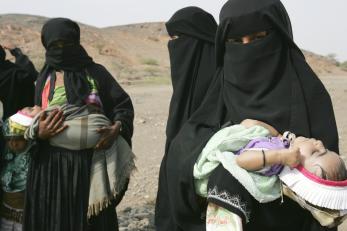 Women holding infants in yemen
