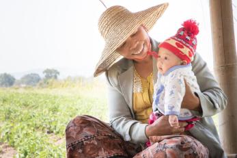 Zar Ni Lwin, a farmer in Myanmar, with her 4-month-old grandson