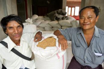 Kyi, pictured left, with a bag of rice