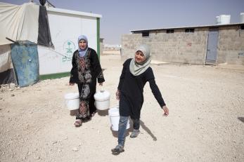 Nour and her mother fetch water using buckets