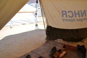Following custom, shoes are removed at the entrance of a family’s tent.